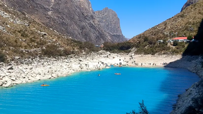 Shore of Laguna Parón with deep blue water