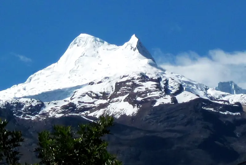 Vallunaraju's two snow-covered summits under a blue sky, seen from Huaraz